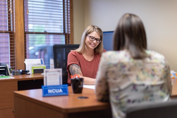 two females in bank office going over paperwork