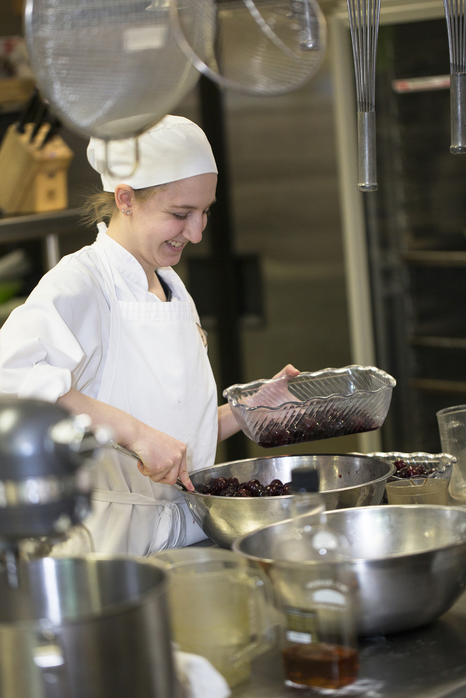 student chef mixing cherries in a bowl