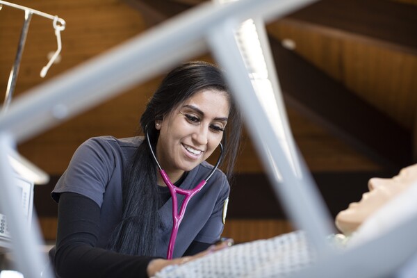 female nursing student checking heartbeat