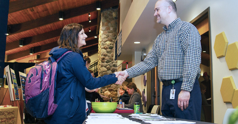 student meeting employer at job fair