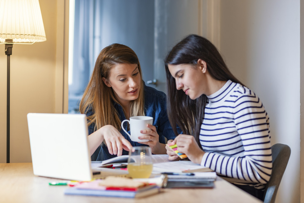 mom and daughter at kitchen table discussing education