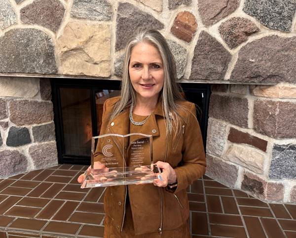 Nicolet College President Kate Ferrel accepts the Open Book Award from CBExchange.