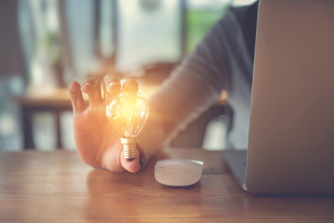 Light bulb idea with desk and laptop