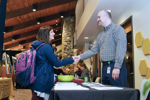 student meeting employer at job fair