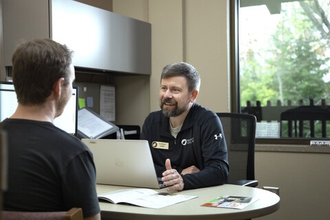 male student meeting with a male admissions rep in an office