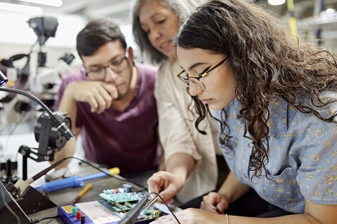 engineering students working on a project with instructor