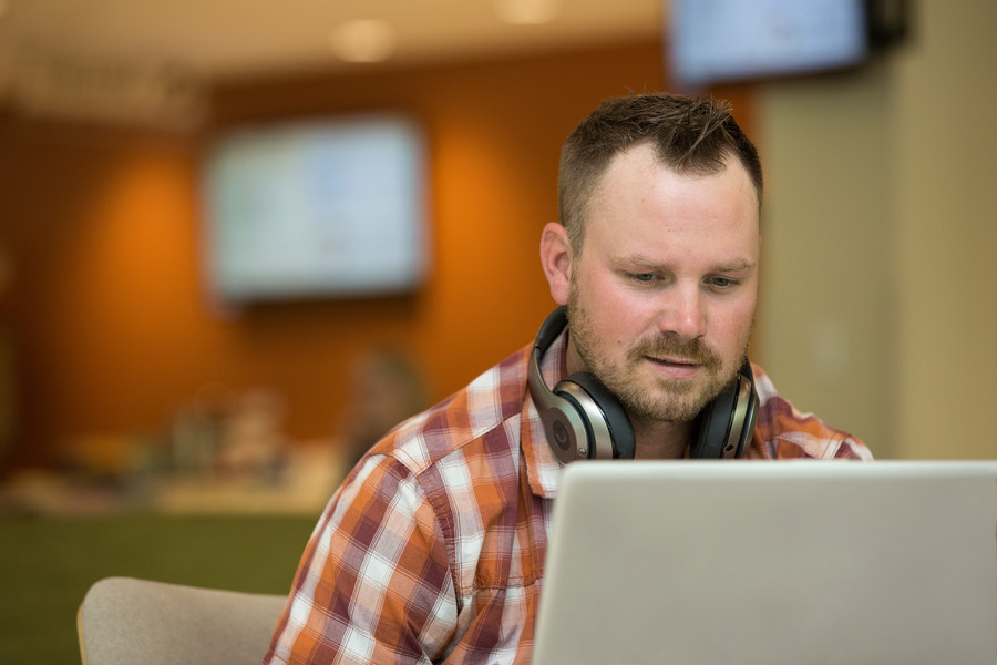 Male studnet working on laptop