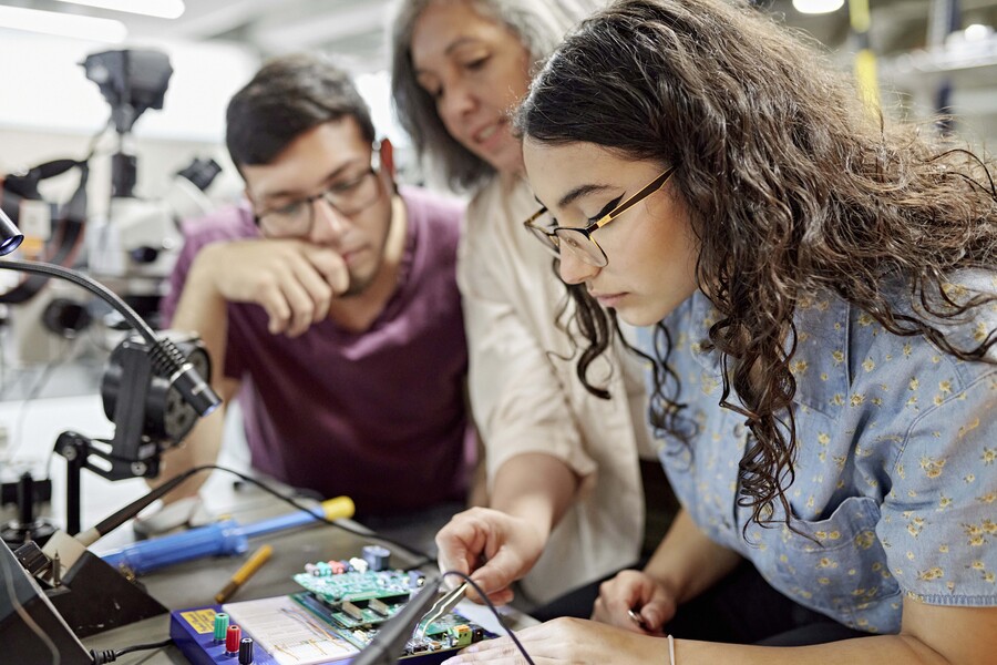 engineering students working on a project with instructor