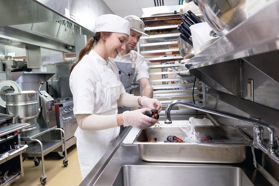Dual credit culinary student working with instructor